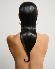 the back of a woman's head with long black hair