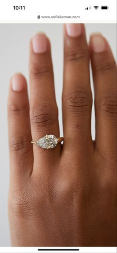 a woman's hand with a diamond ring on top of her finger and the words,