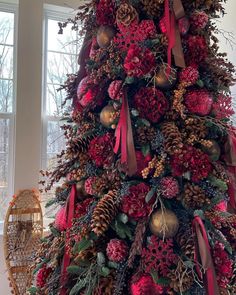 a christmas tree decorated with red and gold ornaments