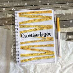 a notebook with the word criminologia written on it next to a pen