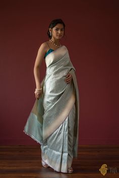 "Handwoven luxury and a rich bed of zari! Inspired by the beauty and geometry of Moroccan artistry, opulent Banarasi craftsmanship and glorious zari come together in this versatile and altogether breathtaking saree.\u00a0\n\u00a0\n\n\n  Color\u00a0-\u00a0A stunning shade of Light Blue\n\n  Technique\u00a0-\u00a0The finest weaving technique passed down through generations of weavers.\u00a0\n\n  Fabric\u00a0- Soft as butter, pure Katan Silk\u00a0\n\n  Speciality\u00a0- This saree features\u00a0beautifully detailed\u00a0geometric weaving\u00a0in silver zari with roopa sona zari borders and pallu. With the right balance of silk, and\u00a0gold and silver zari, this drape strikes the perfect note of elegance.\u00a0\n\n  Tilfi Promise\u00a0- Pure. Handloom. Banaras\nNote - The saree comes with it Twenties Style, Blue Silk Saree, Brocade Saree, Silk Saree Banarasi, Shades Of Light Blue, Blue Saree, Katan Silk, Boutique Dress Designs, Roaring Twenties