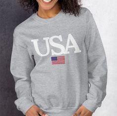 Wrap yourself in the proud colors of the USA with our unisex sweatshirt. Made from high-quality cotton and polyester blend, this sweatshirt offers a soft and cozy feel against the skin. The fabric is lightweight yet durable, ensuring it's perfect for year-round comfort. Available in various sizes, this sweatshirt is designed to fit all body types with ease, providing a versatile addition to your wardrobe. Whether you're attending a Fourth of July celebration, a casual outing, or simply lounging Fourth Of July Celebration, Usa Sweatshirt, Travel Clothing, Travel Gifts, Travel Outfit, Body Types, Unisex Sweatshirt, 4th Of July, Sweat Shirt