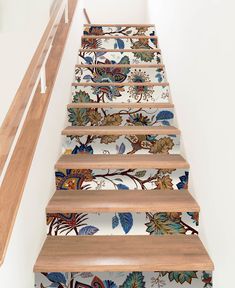 an artisticly designed stair case painted with flowers and leaves