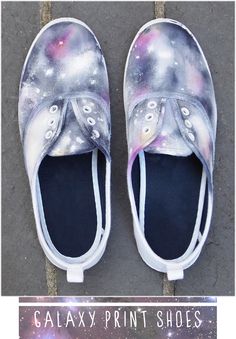 a pair of white shoes with space painted on them