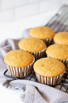 muffins cooling on a wire rack with the words acorn squash muffins