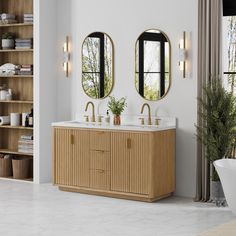 a bathroom with two sinks and mirrors on the wall