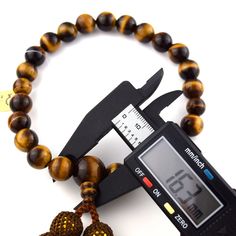 Tiger Eye Japanese Traditional Juzu Buddhist Prayer beads Characteristics of the product Material : Tiger Eye, Silk cord Head bead : about 12mm Main bead : about 8mm Diameter : about 80mm (not stretch) Handmade in Kyoto, JAPAN About juzu One-handed Prayer beads, it can be used by any Buddhist school. In Japan, Buddhists use Prayer beads (Juzu, Nenju). Kyoto is a famous producing center of Prayer beads. Prayer beads are a traditional tool used to count the number of times a mantra is recited, the breaths one takes while meditating, the prostrations, or the repetitions of a buddha's name. About tiger eye Kwown as the gem of courage, the Tiger’s Eye combines properties that promote vitality, help you regain personal power and prevail over emotional blocks. Its bold, encouraging energy is also Adjustable 8mm Beads For Jewelry Making, Brown Hand-knotted Mala As Gift, Spiritual Brown Faceted Beads, Brown Faceted Spiritual Beads, Brown 8mm Beads, Tiger Eye Shaped Bead Bracelets, Tibetan Prayer Beads, Brown Tiger Eye, Buddhist Prayer