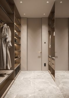 an empty walk in closet with clothes on shelves