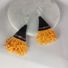 a pair of beaded earrings on a plate