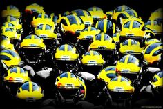 a large group of yellow helmets sitting on top of each other