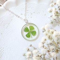 What is "Almost Perfect"?  It's the lowest price on all of our best selling clover necklaces!  This clover has been dyed, but some of the color has slightly bled into the resin. Please purchase only if you understand this condition. -------------------------------------------- ---You will receive 20 mm in diameter size charm necklace.--- I have encased a real four leaf clover (color dyed) in clear resin. The circle charm size is about 20mm diameter, and it is Sterling SILVER charm. This necklace comes with Silver Plated or Sterling Silver 925 chain.  -----------------------------------------------------------  You can purchase SMALL size necklaces fro this link below. Smaller (15mm in diameter) size necklace https://www.etsy.com/listing/510966861/ ------------------------------------------ Sterling Silver Green Jewelry For Good Luck, Green Sterling Silver Jewelry For Good Luck, Green Flower Charm Jewelry With Round Pendant, Green Flower Charm Round Pendant Jewelry, Green Round Pendant Jewelry With Flower Charm, Green Round Jewelry With Birth Flower, Green Birth Flower Round Jewelry, Green Birth Flower Jewelry, Sterling Silver Jewelry With Green Flower Charm