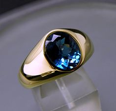 AAA London Blue Topaz 10x8mm 3.21 Carats 14K yellow gold ring 19 grams 0203 This is a great looking stone with a great cut and a rich dark blue yet still has a lot of brilliance. Gem quality stone with no visible inclusions, and a great Portuguese cut. Color as shown in the images. This is natural Topaz from Brazil. Weighs 3.21 carats and measures 10 8mm. The stone in the ring has a checkerboard cut and if you prefer a traditional oval cut with a flat table which is often cut in a Portuguese cut Yellow Gold Mens Rings, Filigree Ring Gold, White Gold Jewelry, Shopping Basket, Mens Gold, London Blue Topaz, London Blue, Men's Rings, Yellow Gold Rings