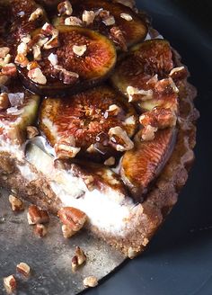 a piece of cake with figs and nuts on it