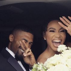 a bride and groom wave from the back of a car as they leave their wedding ceremony