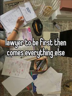 someone sitting at a desk with papers and pencils in front of them that says, law to be first then comes everything else