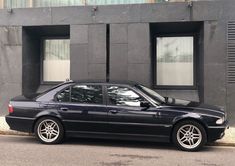 a black car parked in front of a building