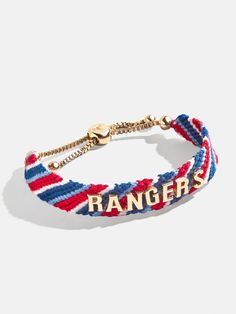 Proudly show off your team loyalty with the Texas Rangers MLB Woven Friendship bracelet. This bracelet is crafted with colorful woven thread, which creates a vibrant backdrop for your favorite game day rallying cheer. Secured with an easy pull-tie closure, this spirited and nostalgic accessory will be loved by fellow fans all season long. Please note: due to their handmade nature, each bracelet will be slightly unique. This is an officially licensed MLB product. Adjustable Team Spirit Friendship Bracelets For Game Day, Casual Adjustable Wristband For Game Day, Casual Adjustable Wristband For Fan Merchandise, Team-colored Wristband For Game Day, Casual Multicolor Bracelets For Game Day, Team Bracelets, Ny Rangers, Rallying, Texas Rangers