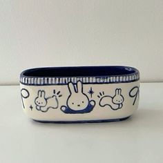 a blue and white bowl sitting on top of a table