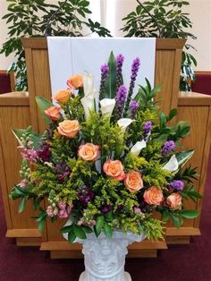 a vase filled with lots of flowers on top of a table