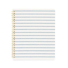 a spiral notebook with blue and white stripes on the front, lined in gold foil