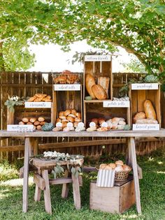 an outdoor table with bread boxes and baskets on it