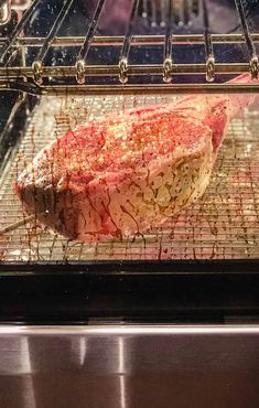 a piece of meat is cooking in an oven