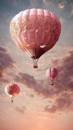 three hot air balloons flying in the sky with clouds and sun shining through them,