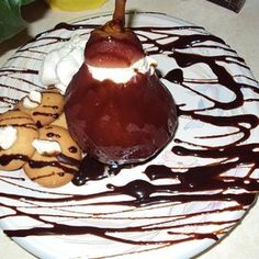 a plate with cookies, ice cream and caramel on it that is drizzled in chocolate