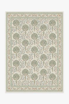 a white and green rug with trees on it, in the middle of a floral pattern