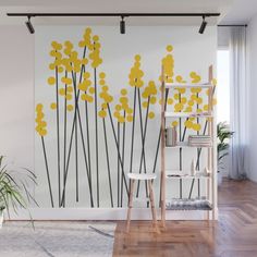 yellow flowers on white wall mural in living room with wood flooring and wooden ladder