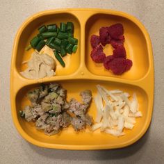 a yellow tray with three compartments filled with food