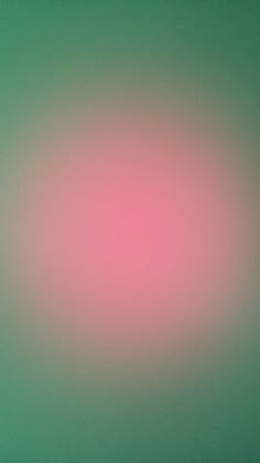 a blurry image of a pink and green background with the light reflecting on it