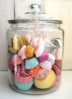 a glass jar filled with lots of colorful seashells