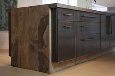 a kitchen island made out of wood and metal