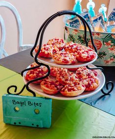 three tiered trays filled with pizza on top of a table