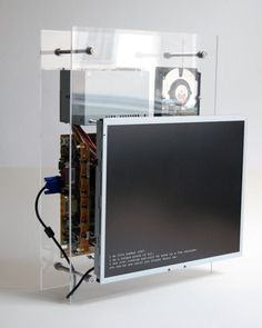 an electronic device is shown in a clear plastic case on a white surface with wires attached to it