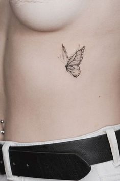 a woman's stomach with a butterfly tattoo on her belly and the bottom part of her body