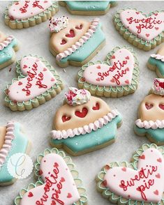 decorated heart shaped cookies are arranged on a table