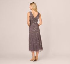 a woman in a purple dress is looking back