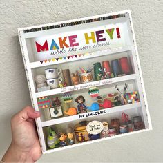 a person holding up a poster that says make hey while the sun shines on it