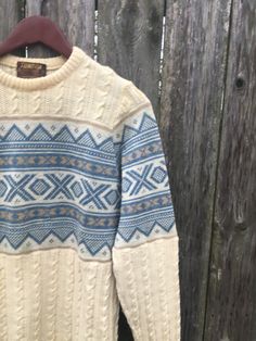 This is a cool sweater for anyone that loves the 50's and 60's. If you want to look great everywhere you go, get this beauty now. It is in okay condition but has staining at the bottom and on the sleeve, all pictured. We didn't have it dry cleaned so it could come out. There are no rips, holes or smells. Measurements: Pit to pit: 18 inches Collar to bottom front: 23 1/2 inches Collar to bottom back: 26 inches Sleeve Length (from collar): 27 inches Size on tag: Small Retro Knitted Sweater For Fall, Retro Knitted Sweater For Winter, Retro Beige Knitted Sweater, Beige Knitted Retro Sweater, Cream Jacquard Knit Winter Sweater, Cream Jacquard Knit Sweater For Winter, Retro Cotton Sweater With Knit Fabrication, Retro Cotton Knit Sweater, Retro Cotton Sweater For Fall