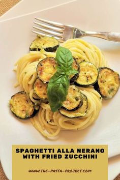 spaghetti alla nerano with fried zucchini on a white plate next to a fork