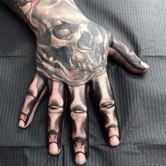 a person with tattoos on their hands and fingers