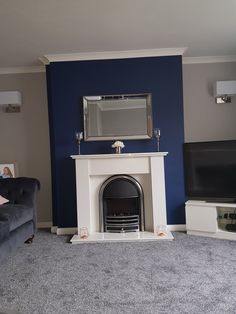 a living room with blue walls and a fireplace