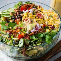 a glass bowl filled with salad and dressing