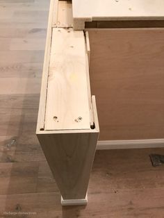 an unfinished drawer is sitting on the floor