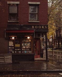 a book store sitting on the side of a street next to a tall red brick building