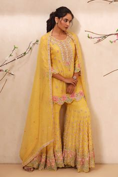 Yellow bamberg silk straight kurta with all over zardozi work in floral pattern. Paired with embroidered sharara and dupatta.
Component: 3
Pattern: Embroidered
Type Of Work: Zardozi Work
Neckline: Round
Sleeve Type: Three Quarter
Fabric: Bamberg Silk, Lining: Cambric
Color: Yellow
Other Details: 
Cutwork hem on kurta and sharara
Side slits on kurta
Occasion: Haldi and Mehendi,Sangeet - Aza Fashions Embroidered Sharara, Kurta Sharara Set, Zardozi Work, Kurta Sharara, Indian Prints, Straight Kurta, Sharara Set, Indian Fashion Dresses, Cut Work