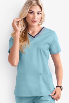 Ready to spice up your day with something sporty? The contrast detail on our women’s rounded v-neck scrub top adds a pop of color and an athletic touch. Each piece in our Butter-soft Stretch scrub collection was designed for 12+ hour shifts, and made from easy-care, 2-way stretch comfort fabric. • Classic fit • V-neck • Contrast trim and piping • Total of 4 pockets • 2 double front pockets • Short sleeve • Side vents • Back darts • Approximate length for size M is 27 1 2 The key to comfort? Cott Blue Sports Tops With Pockets, Stretch Sports Tops With Pockets, Navy Sporty Top With Pockets, 12 Hour Shifts, Uniform Advantage, Medical Uniforms, Scrub Tops, Contrast Trim, Shorts With Pockets