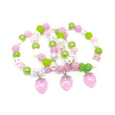 These adorable bracelets are the perfect favor for your little one's strawberry party! Each bracelet features an enameled, gold plated charm, resin rhinestone beads and an assortment of 10mm acrylic beads in red, dark green, pink and bright green strung with durable stretch floss cord. Your bracelets will arrive individually packaged in color coordinating organza bags. If you would like your bracelets made in a different color combination, just let me know! I can make your bracelets to match you Personalized Sweet Bracelets As Gift, Sweet Personalized Bracelets As Gift, Sweet Pink Hypoallergenic Jewelry, Sweet Personalized Adjustable Jewelry, Personalized Adjustable Sweet Style Jewelry, Sweet Adjustable Personalized Jewelry, Sweet Adjustable Stretch Bracelet For Gift, Pink Bracelet For Party Favors, Cute Round Beads Jewelry For Party Favors